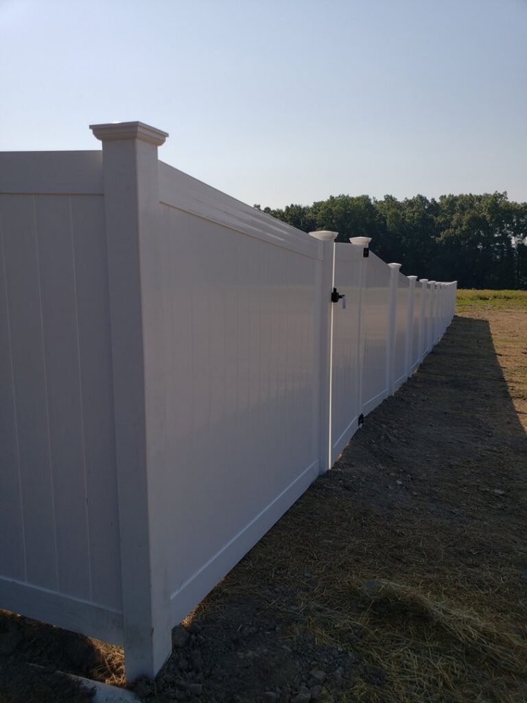 A new white vinyl privacy fence with a gate installed by Lee Fence and Outdoor in York, PA.