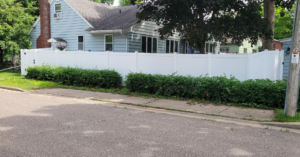 A white vinyl privacy fence installed along a street for a home by Cyclone Fence in Somerset, WI.