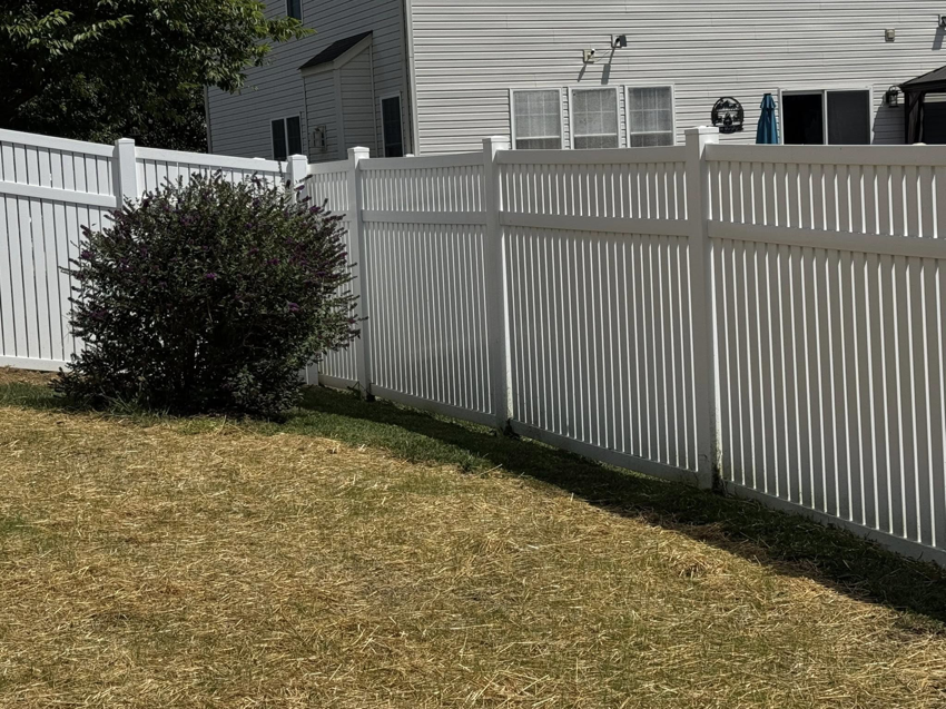 Professional installation of a white vinyl privacy fence in a residential backyard by Lee Fence and Outdoor in York, PA.