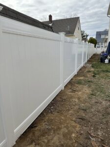 New white vinyl privacy fence being installed at a residential property by National Fence Systems, Inc. in Avenel, NJ.