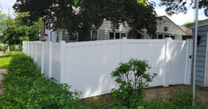A white vinyl privacy fence with a matching gate installed by Cyclone Fence in Somerset, WI.