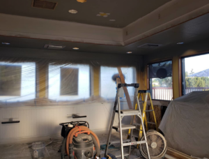 A wide view of an interior room renovation showing tools, ladders, and a shop vacuum by RG Construction WA, LLC in Portland, OR.