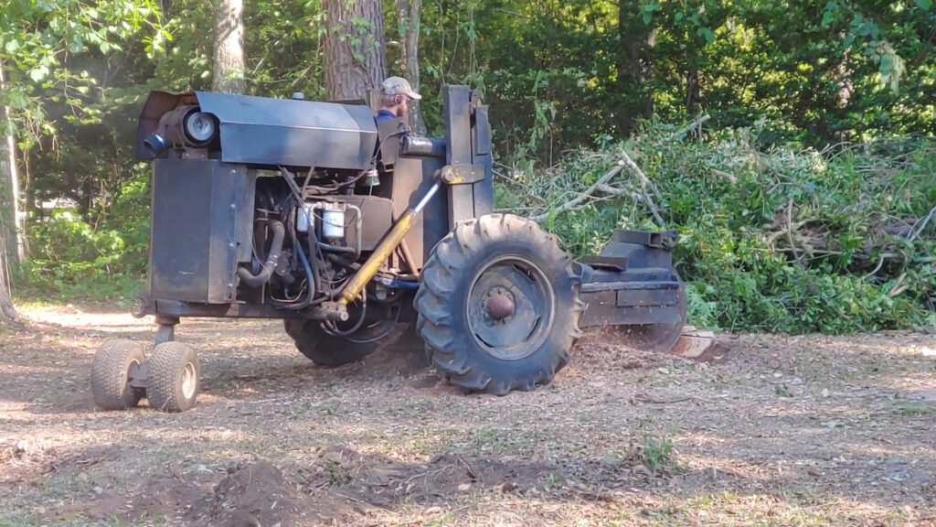 A wide view of a tree trimming operation with a lift bucket by Mr. Stump Tree Service in Colorado Springs, CO.