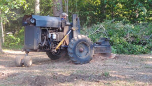 A wide view of a tree trimming operation with a lift bucket by Mr. Stump Tree Service in Colorado Springs, CO.