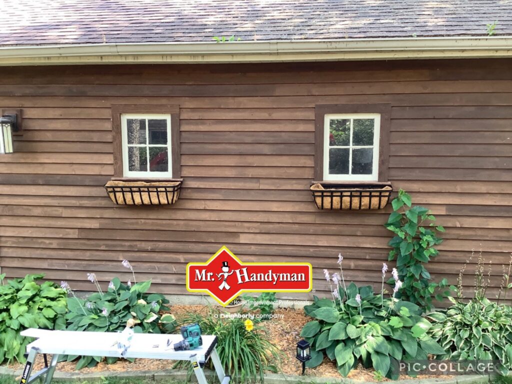 Newly installed window boxes on a house exterior with tools on a workbench by Mr. Handyman of Waukesha and North Milwaukee County, WI.