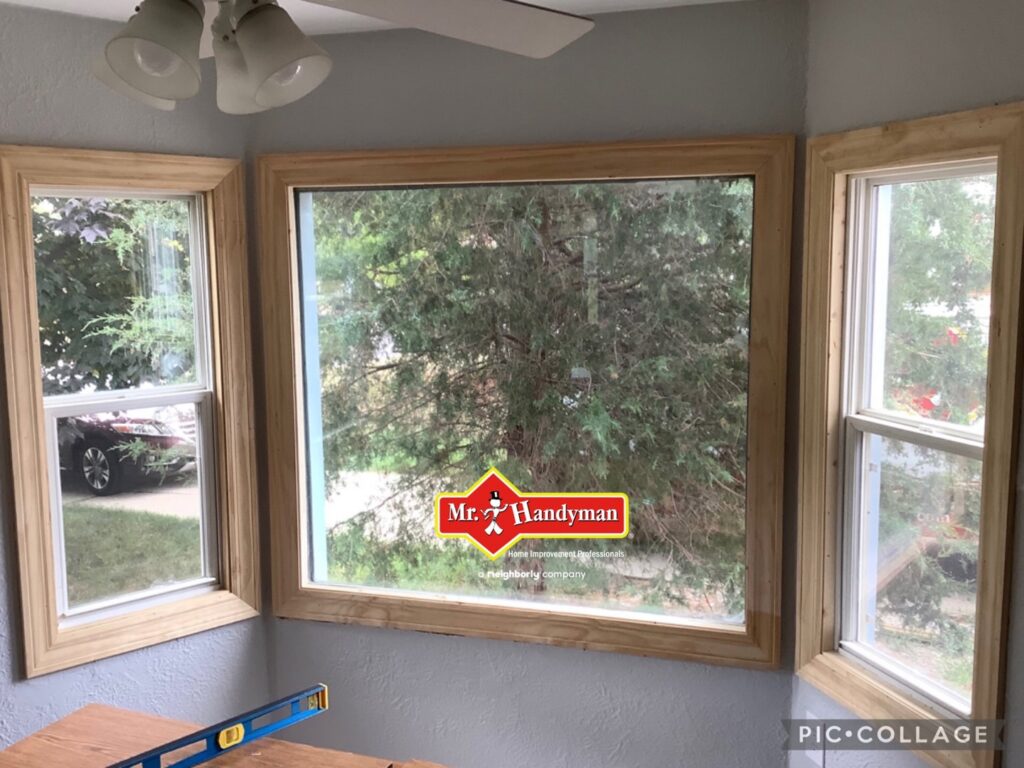 Newly installed window frames with a level tool on the table by Mr. Handyman of Waukesha and North Milwaukee County, WI.
