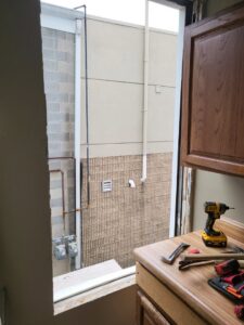 Window removal and preparation for new installation with tools by Green Man's Contracting & Landscaping LLC in West Hartford, CT.