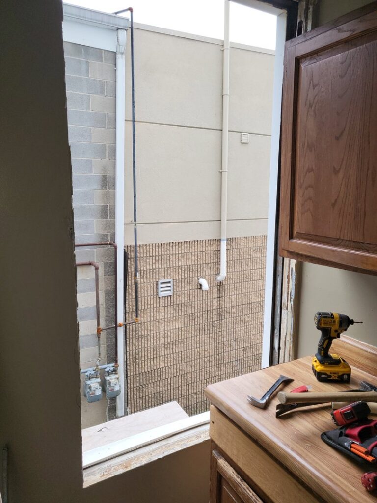 Window removal and preparation for new installation with tools by Green Man's Contracting & Landscaping LLC in West Hartford, CT.