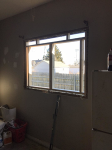 Interior view of a window replacement in progress with tools on the floor by Choice Contractors LLC in Fort Wayne, IN.