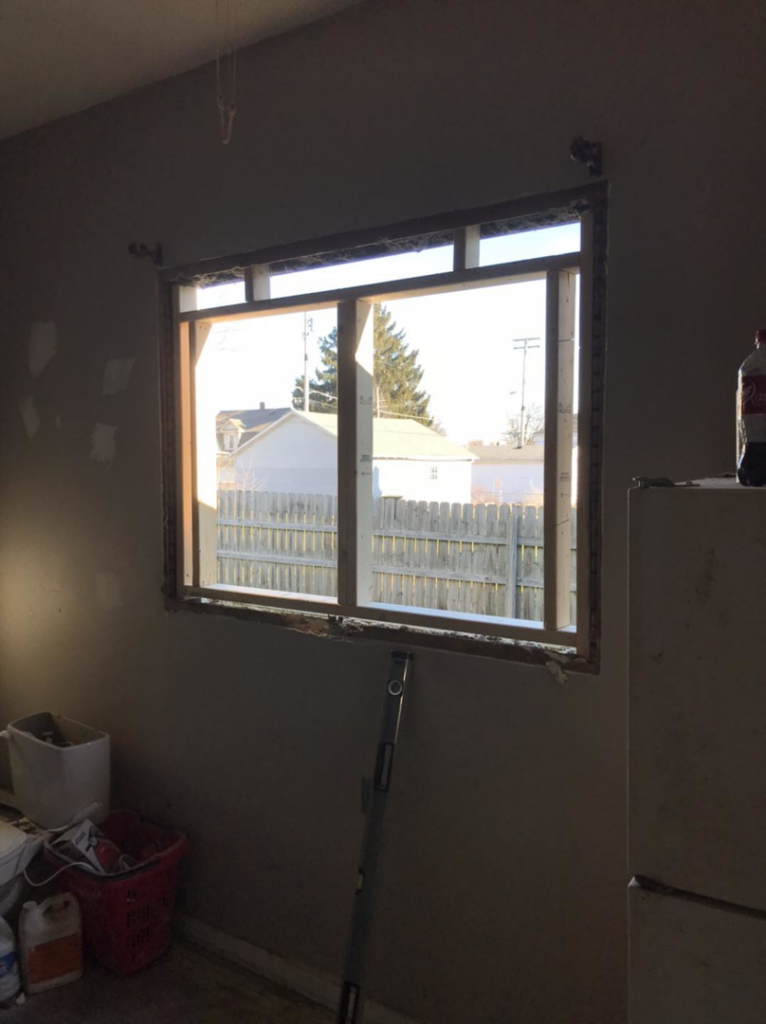 Interior view of a window replacement in progress with tools on the floor by Choice Contractors LLC in Fort Wayne, IN.