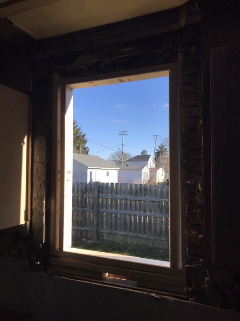 Interior view of a window opening during replacement, showing rough framing by Choice Contractors LLC in Fort Wayne, IN.