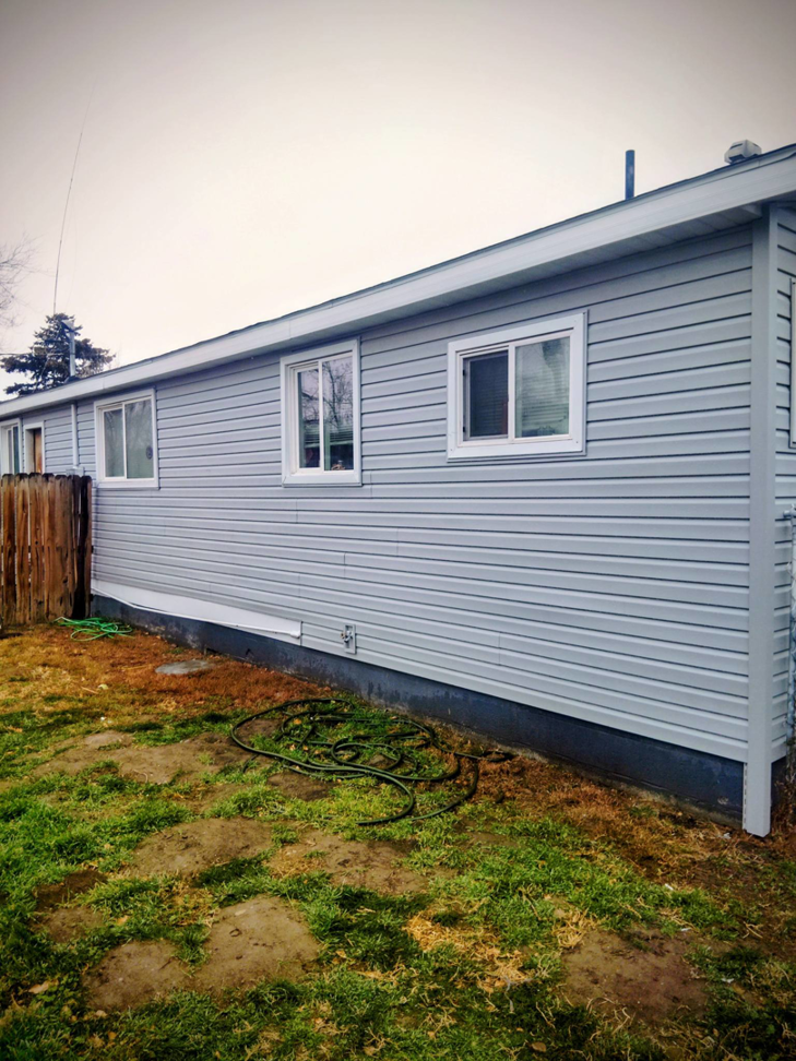 Window replacement and siding installation on a house by Investment Handyman Services in Pocatello, ID