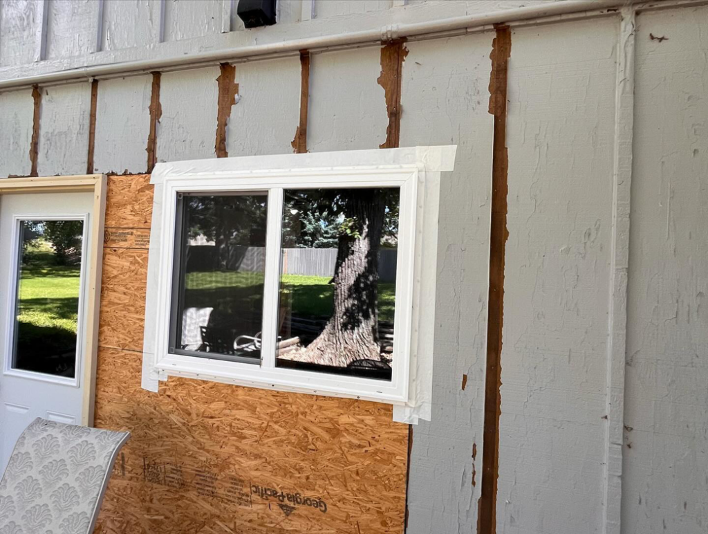 A new window installed in a home with siding repair in progress by McDonald Residential Contracting in Ames, IA.