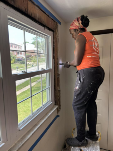 A worker removing old window trim during a home renovation by Ridgely Home Services LLC in Pittsburgh, PA.