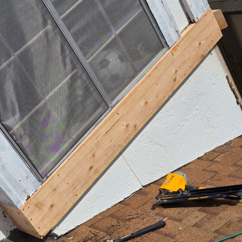 Handyman repairing window trim with a nail gun at a home by Danny's Remodeling in Chandler, AZ.