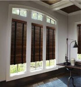 An interior view of a window with dark wooden blinds installed by Pocatello Handyman in Pocatello, ID