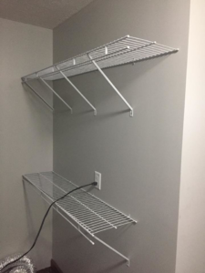White wire shelving units expertly installed on a wall by Kline Custom Homes and Remodelers in Canton, OH.