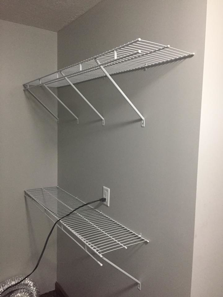 White wire shelving units expertly installed on a wall by Kline Custom Homes and Remodelers in Canton, OH.
