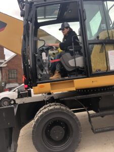 A woman operating heavy machinery at Queen City Metal Recycling & Salvage in Charlotte, NC.