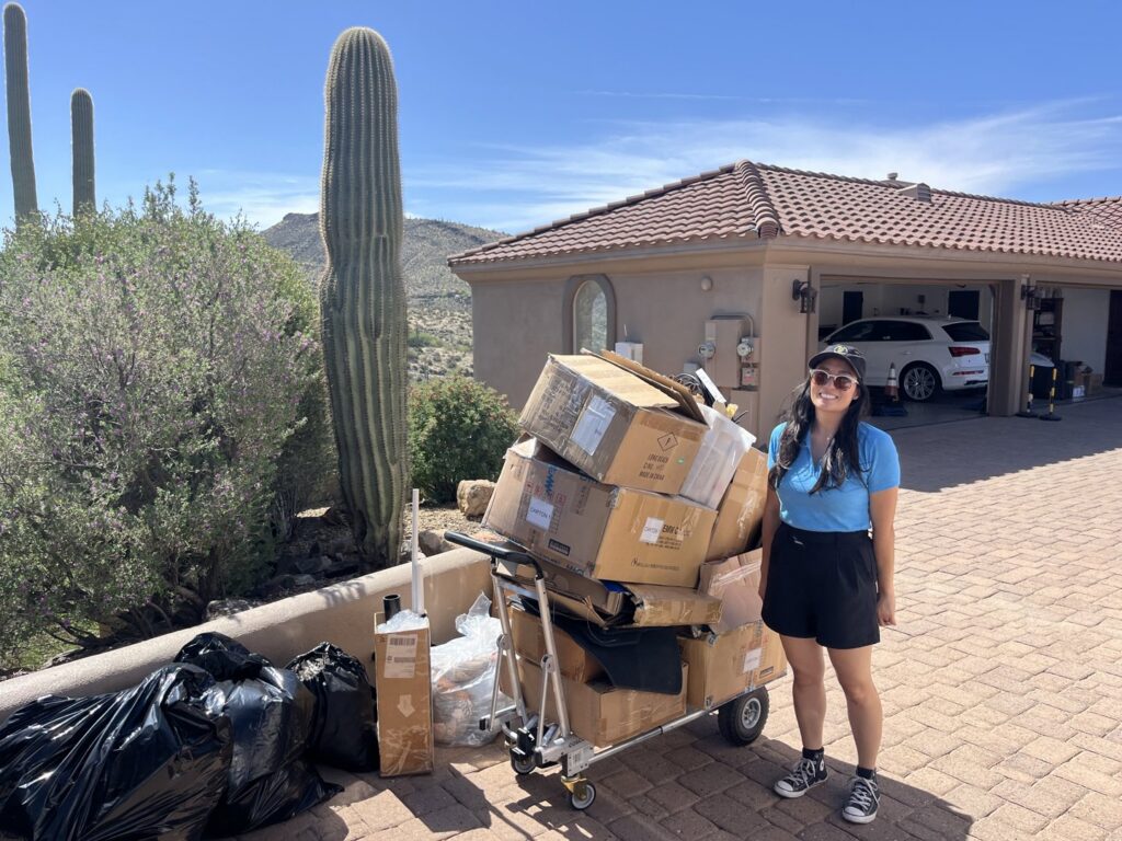 A Happy Hippo Junk Removal team member with boxes and junk ready for pickup in Scottsdale, AZ.