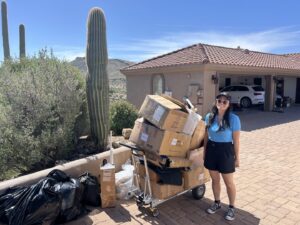 A Happy Hippo Junk Removal team member with boxes and junk ready for pickup in Scottsdale, AZ.