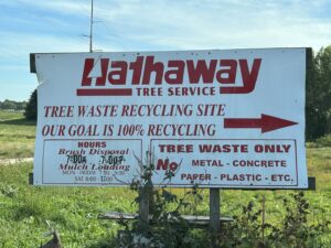 Piles of wood chips and mulch separated by concrete barriers at Wood Recycling Site / Brush Dump in Rochester, MN