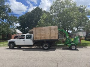 A Vermeer wood chipper and truck ready for debris removal by Broccolo Tree Care in Rochester, NY.