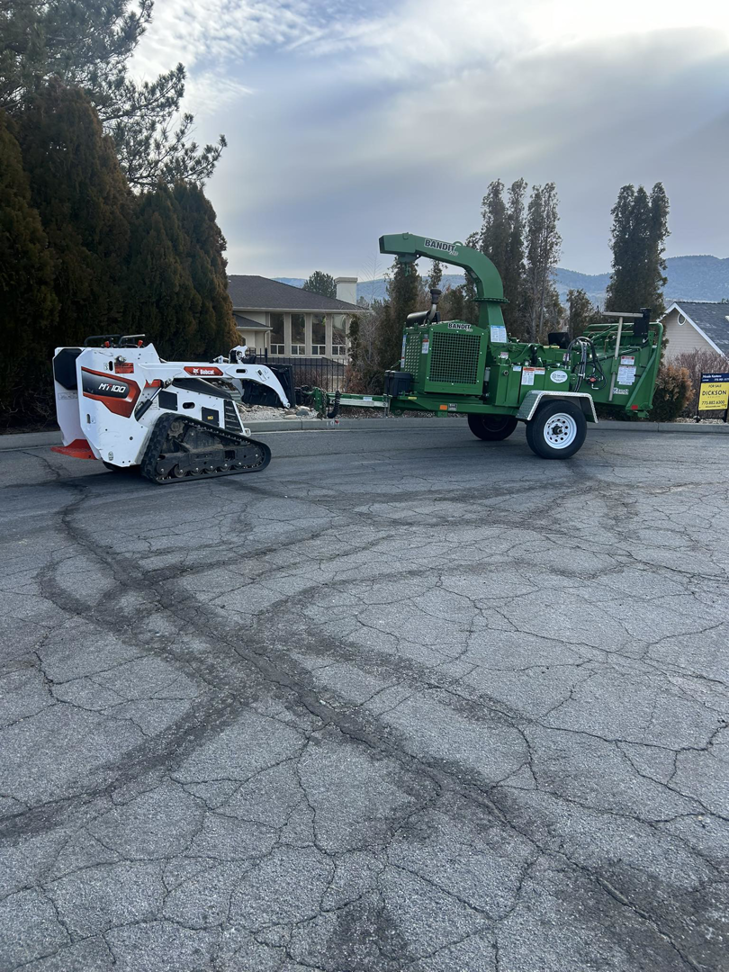 A wood chipper and compact track loader, essential tree service equipment from Capital Tree Care LLC in Carson City, NV.