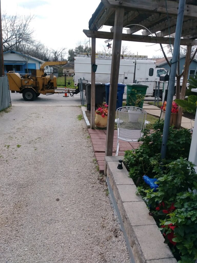 A yellow wood chipper machine used for debris removal by Suarez Tree Service in San Antonio, TX.