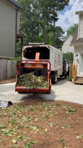 A wood chipper full of branches and debris from a tree service job by Sergeant tree service in Atlanta, GA