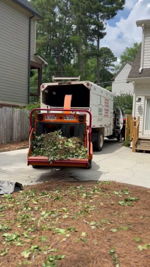 A wood chipper full of branches and debris from a tree service job by Sergeant tree service in Atlanta, GA