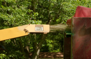 A wood chipper processing tree debris, a common service provided by Big Island Tree Service in Keaau, HI