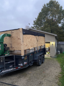 A large wood chipper and debris trailer used by MDW Lawn care & Snow Removal for tree service in Livonia, MI.