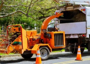 A wood chipper attached to a truck, ready for tree debris removal by Pittsburgh Tree Trimming & Removal Service in Pittsburgh, PA.