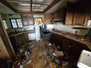 A truck and trailer loaded with wood debris, with a bobcat nearby, handled by Haul-R-Us Junk Removal LLC in Fresno, CA.