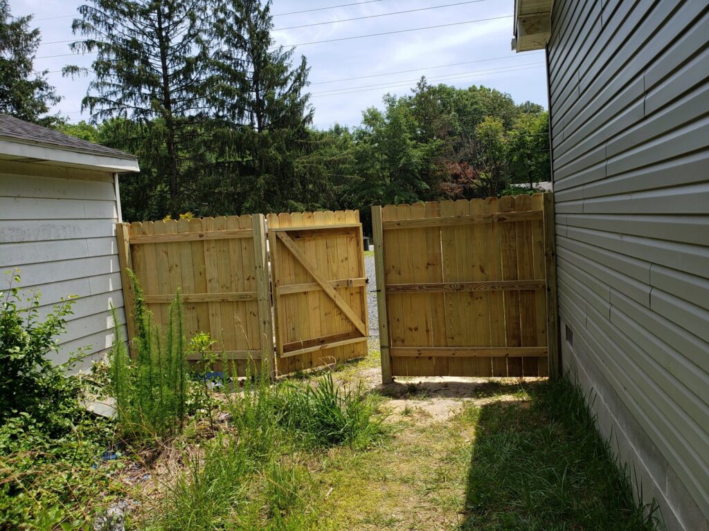 Newly installed wooden fence and gate by Priority Property Services in Salisbury, MD.