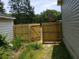 Newly installed wooden fence and gate by Priority Property Services in Salisbury, MD.
