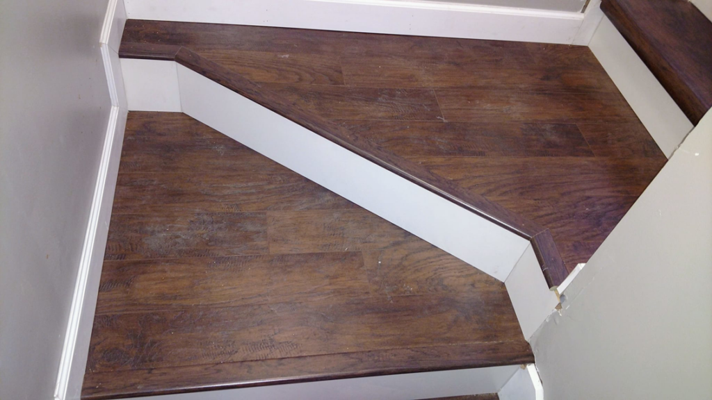 Professional wood-look flooring installation on a staircase and landing by Northup Flooring LLC in Greenville, SC.
