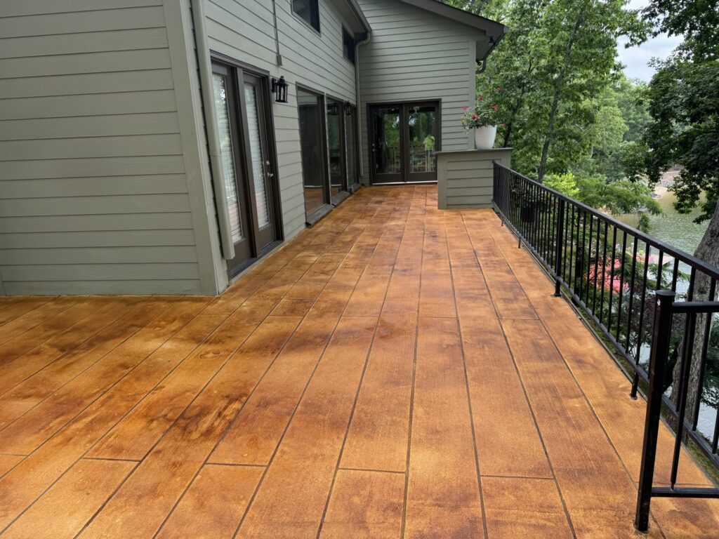 A spacious deck with a realistic wood-look stamped concrete surface, installed by Rodriguez Concrete Creations in Rock Hill, SC.