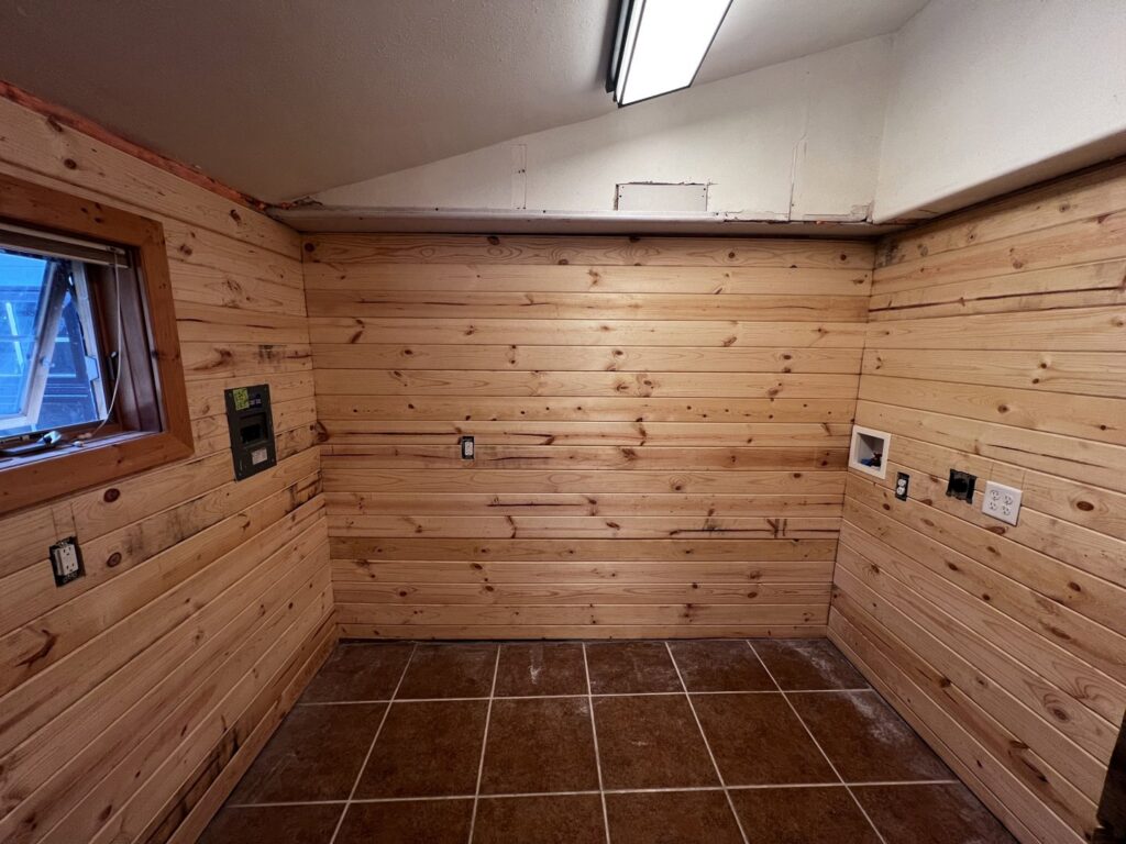 Wood paneling and electrical outlet installation in a room by Iron Horse Handyman Services LLC in Laramie, WY.