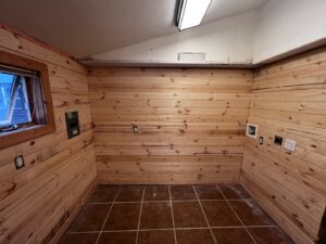 Wood paneling and electrical outlet installation in a room by Iron Horse Handyman Services LLC in Laramie, WY.