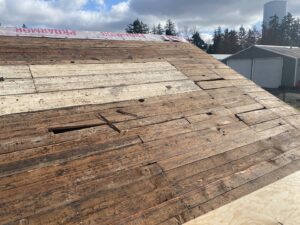 Exposed wood plank roof decking during a repair project by Sunny's roofing LLC in Denver, CO.