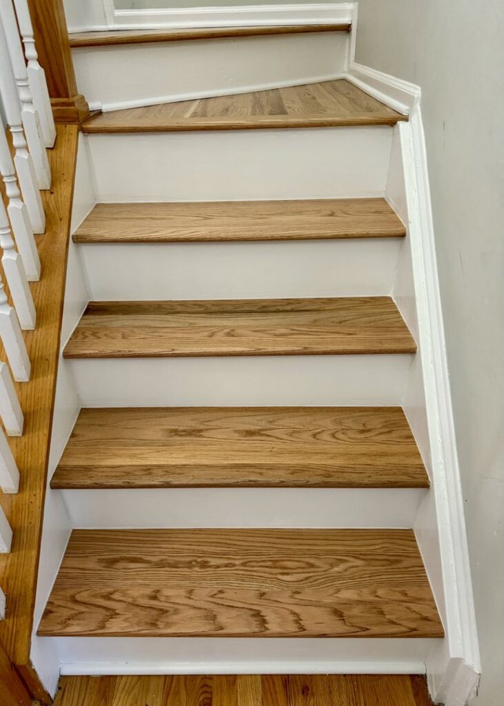 New wood stair treads and white risers installed by Santizo Flooring & Painting in Raleigh, NC.