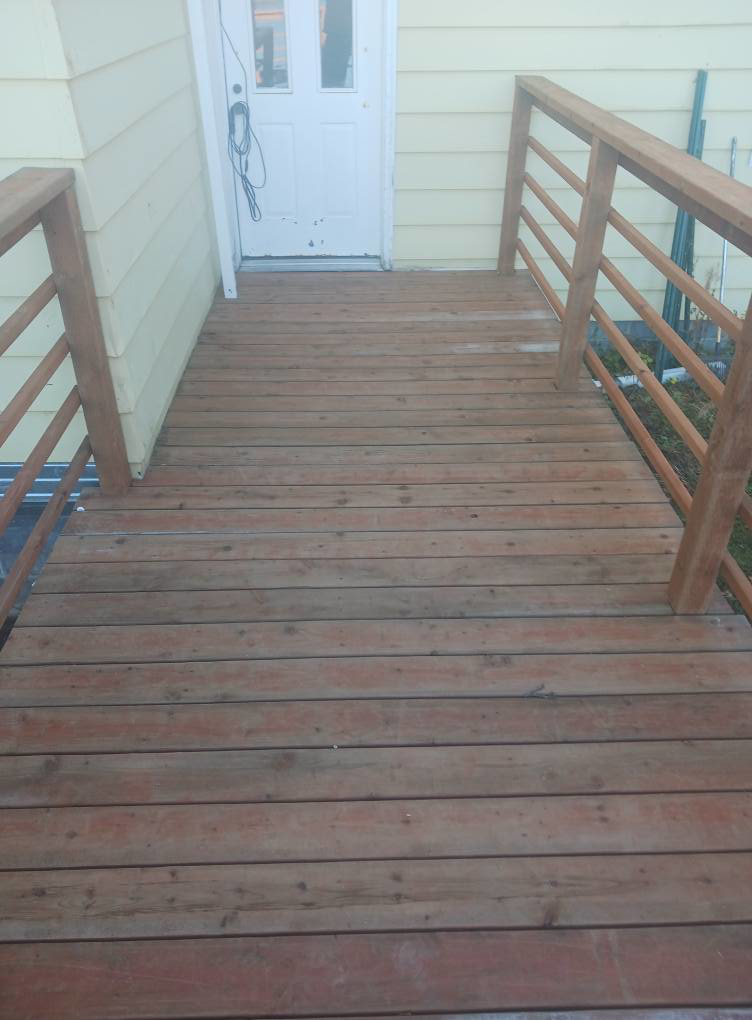 A newly constructed wooden access ramp leading to a house entrance, built by RS handyman llc in Kenai, AK.