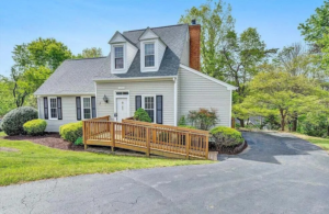 A newly constructed wooden accessibility ramp leading to the front door of a house by Gray Fox Enterprises in Roanoke, VA