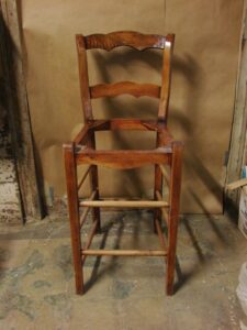 A wooden chair undergoing repair or refinishing in the workshop of Custom Carpentry Service in Knoxville, TN.
