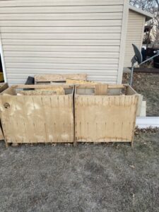 Wooden crates filled with construction debris and wood scraps ready for removal by TrashnSell in Grand Island, NE