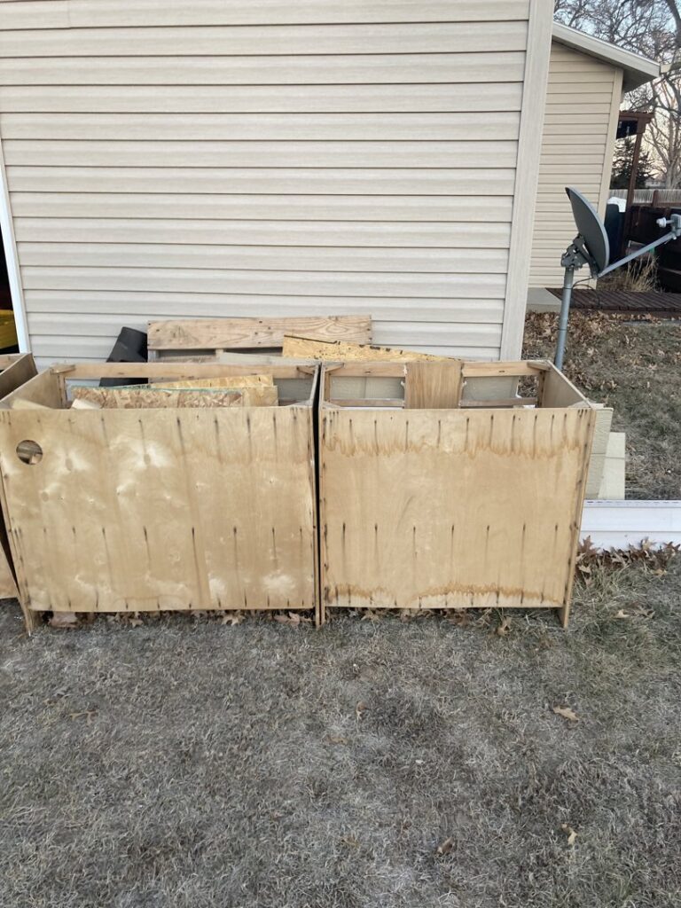 Wooden crates filled with construction debris and wood scraps ready for removal by TrashnSell in Grand Island, NE