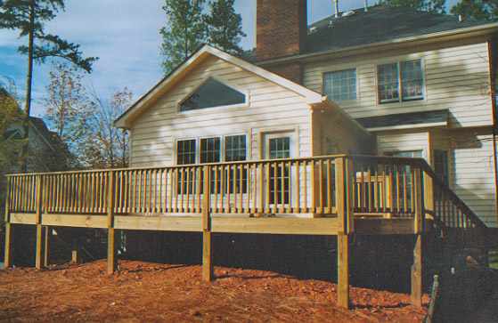 A newly built wooden deck and home addition, expertly crafted by Tim Moss & Sons Home Improvement in Greensboro, NC.
