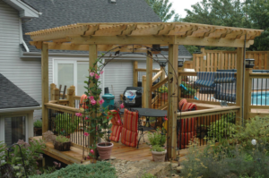 A custom-built wooden deck with a pergola and outdoor living space by Holm Remodeling Company in Kansas City, KS.